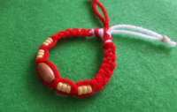 knit bracelet martenitsa with wooden beads